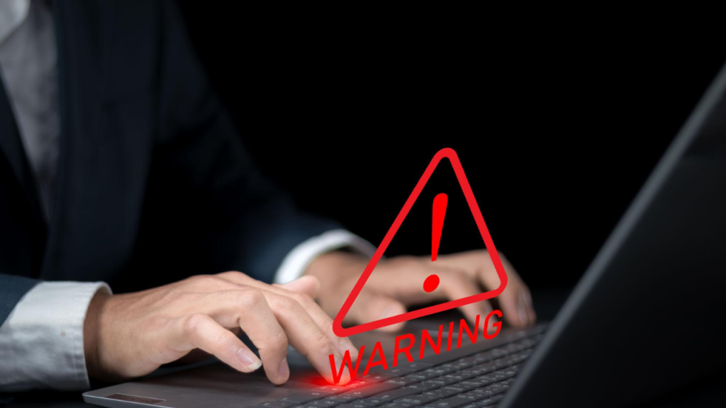 Warning message identifying a fake website and online scam on a laptop screen